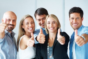 Business approval - Portrait of confident young colleagues with thumbs up sign